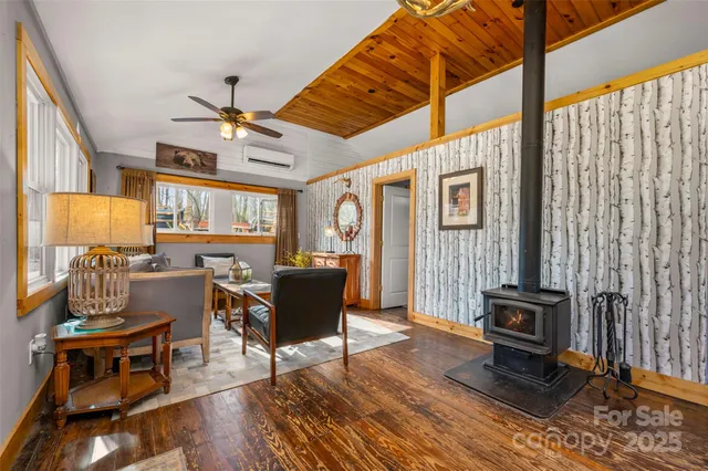 a living room with furniture a fireplace and windows