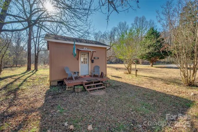 a view of a yard with a wooden fence