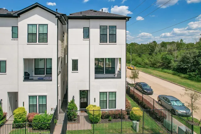 a view of a house with a yard and a garage