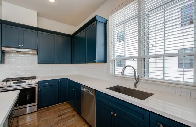 a kitchen with a sink and large window