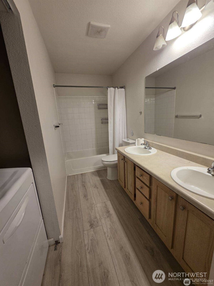 31500 33rd Place Southwest, Unit U101 Federal Way, WA 98023 - Photo 11 of 27 a bathroom with double vanity sink and mirror