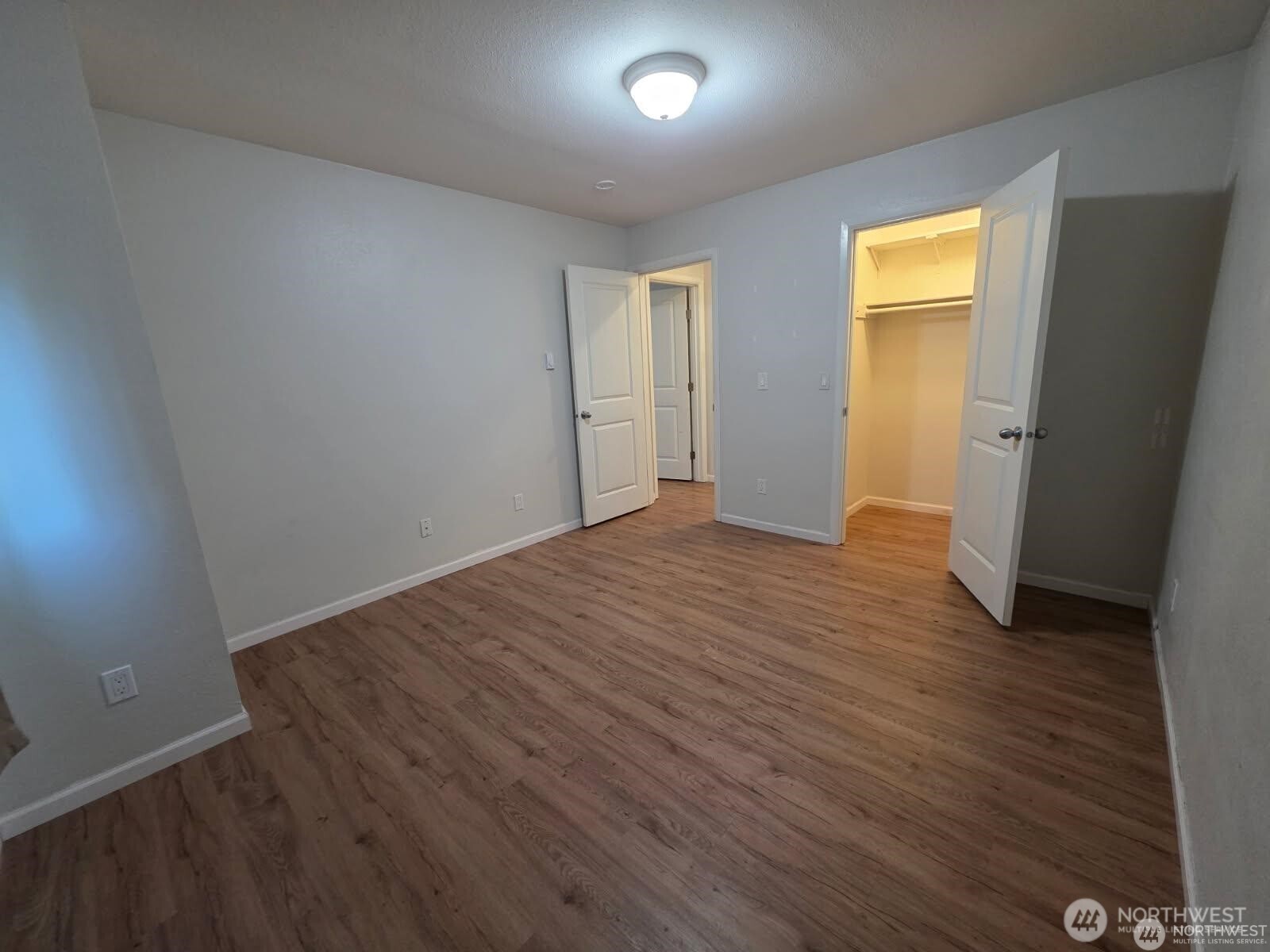 31500 33rd Place Southwest, Unit U101 Federal Way, WA 98023 - Photo 13 of 27 an empty room with wooden floor and windows