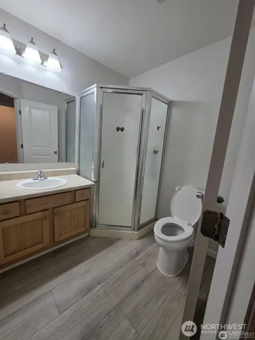 a spacious bathroom with a double vanity sink toilet and a tub
