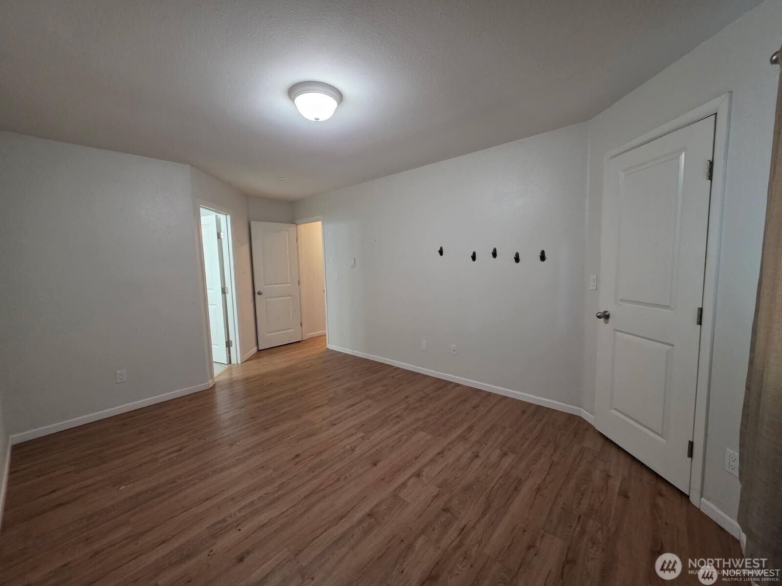 31500 33rd Place Southwest, Unit U101 Federal Way, WA 98023 - Photo 16 of 27 a view of an empty room with wooden floor