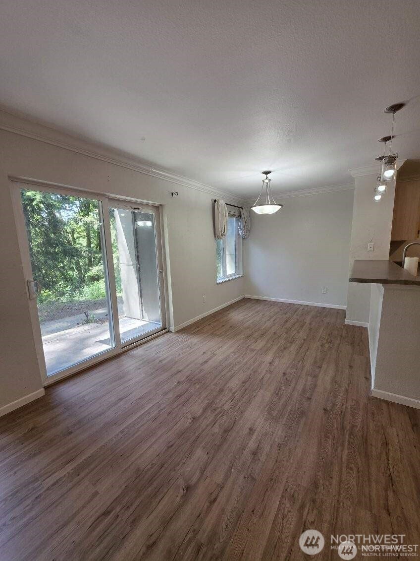 31500 33rd Place Southwest, Unit U101 Federal Way, WA 98023 - Photo 7 of 27 a view of a room with wooden floor and a window