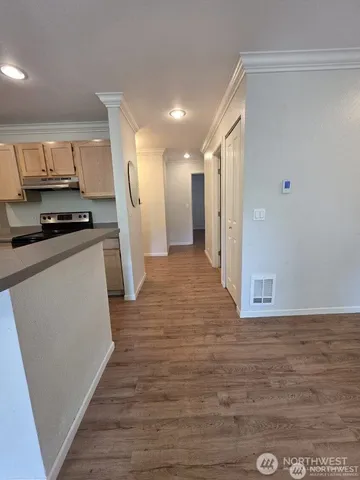a view of a kitchen with wooden floor