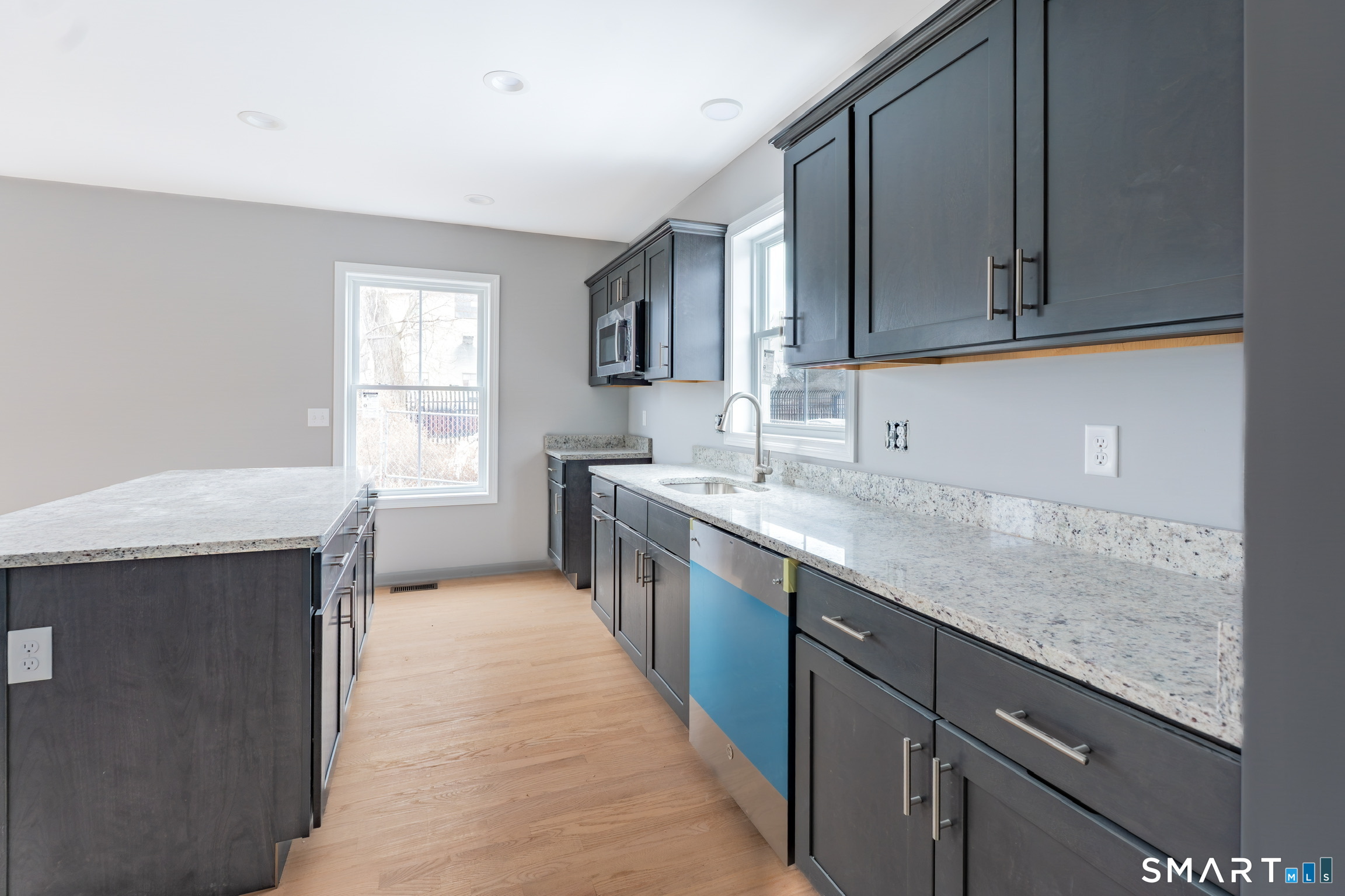 29 Hall Avenue Wallingford, CT 06492 - Photo 8 of 16 a kitchen with stainless steel appliances granite countertop a sink stove and cabinets