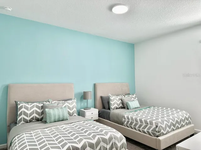 a bedroom with a bed and a lamp