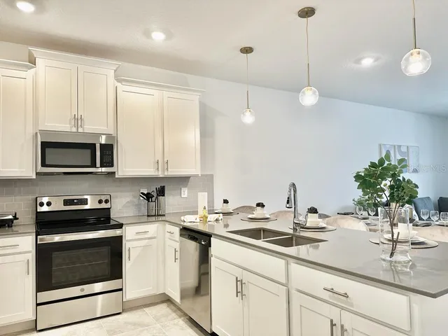 a kitchen with a sink stove and microwave