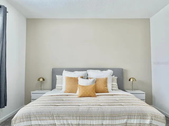 a bedroom with a bed and a lamp