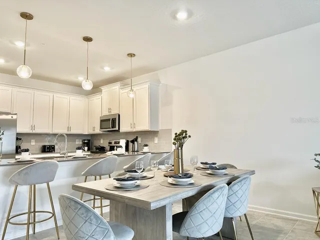a kitchen with stainless steel appliances kitchen island granite countertop a sink and cabinets