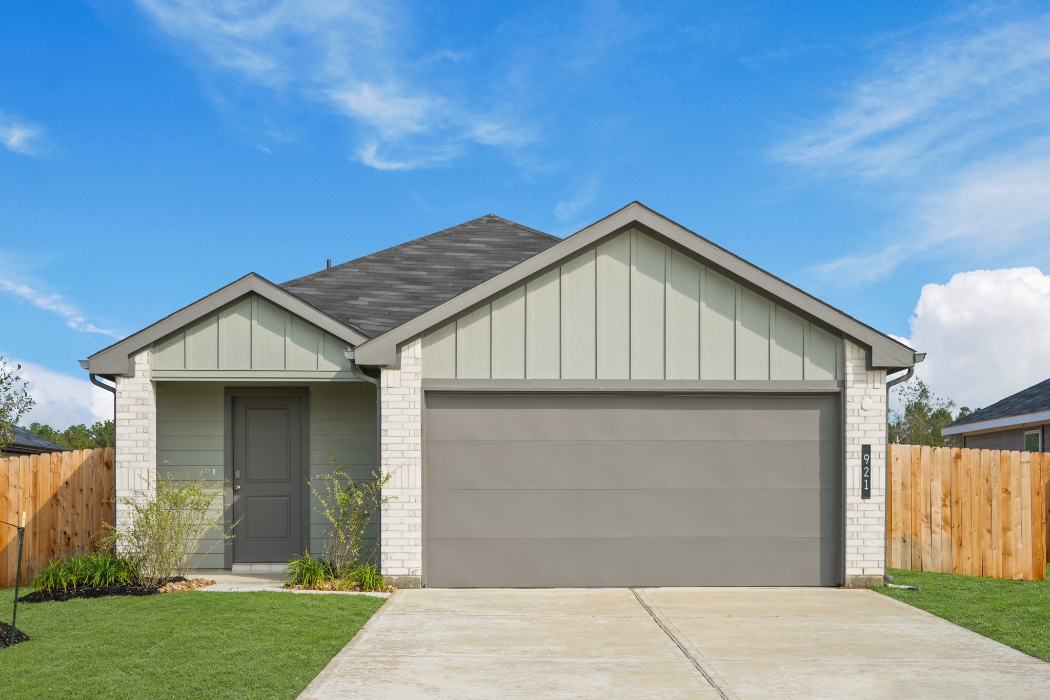 a front view of a house with a garden and yard