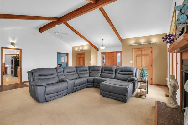 a spacious bedroom with a bed and a chandelier