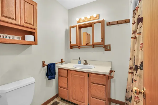 a view of a house with a big yard and large trees