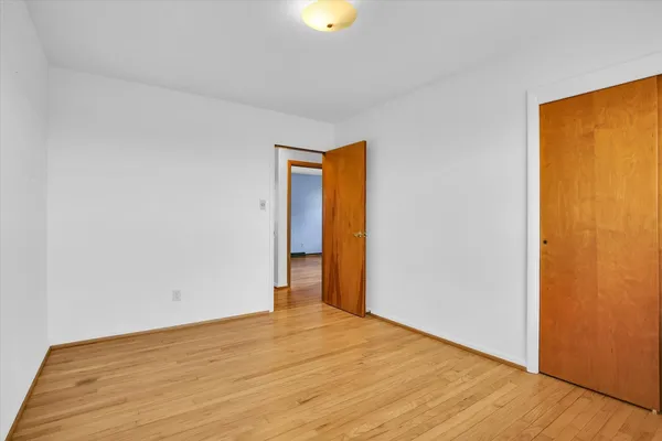 a view of a fountain in front of a house with a big yard