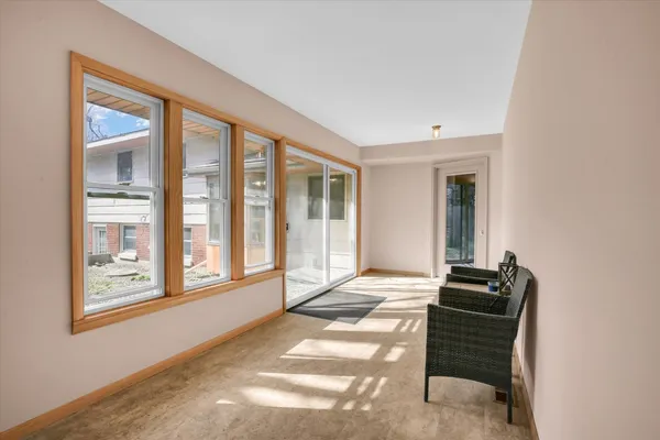 a living room with furniture and large window