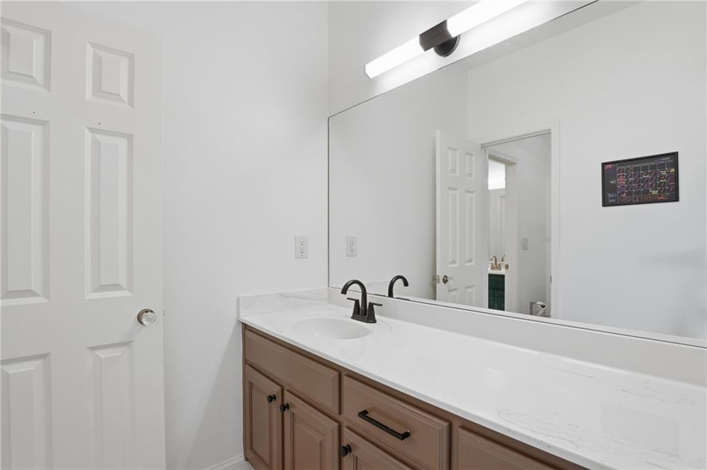 2950 Callie Still Road Lawrenceville, GA 30045 - Photo 35 of 77 a bathroom with a sink and a mirror