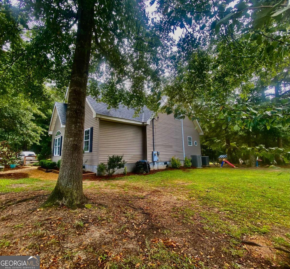 290 Poplar Creek Road Stephens, GA 30667 - Photo 12 of 68 a view of a house with backyard and garden