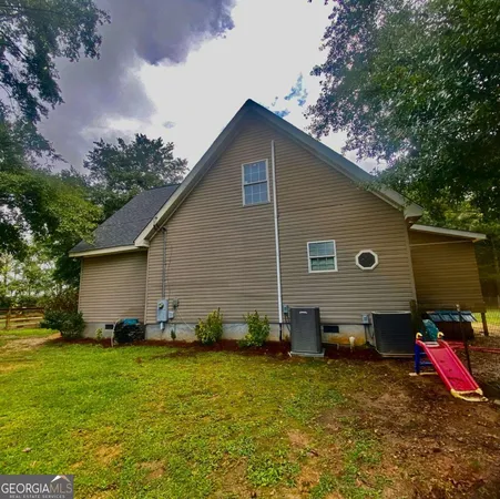 a view of a house with pool and sitting area