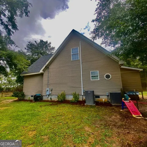 a view of a house with pool and sitting area