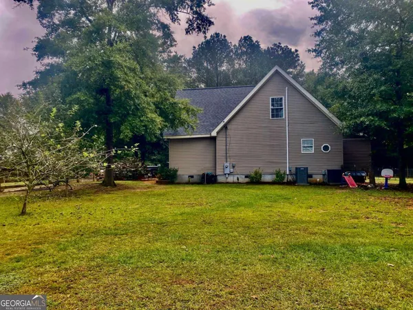 a house view with a sitting space and garden