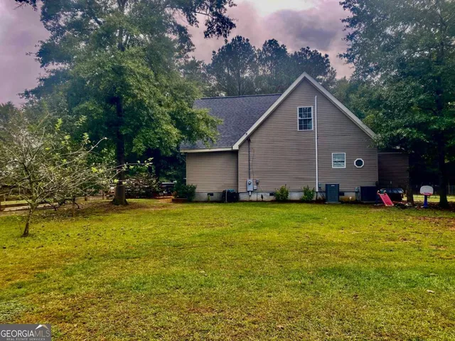 a house view with a sitting space and garden