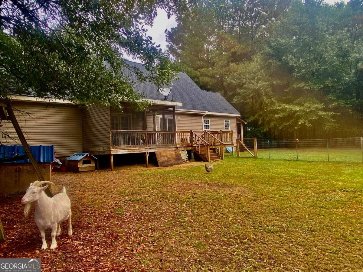 290 Poplar Creek Road Stephens, GA 30667 - Photo 16 of 68 a house view with a sitting space and garden