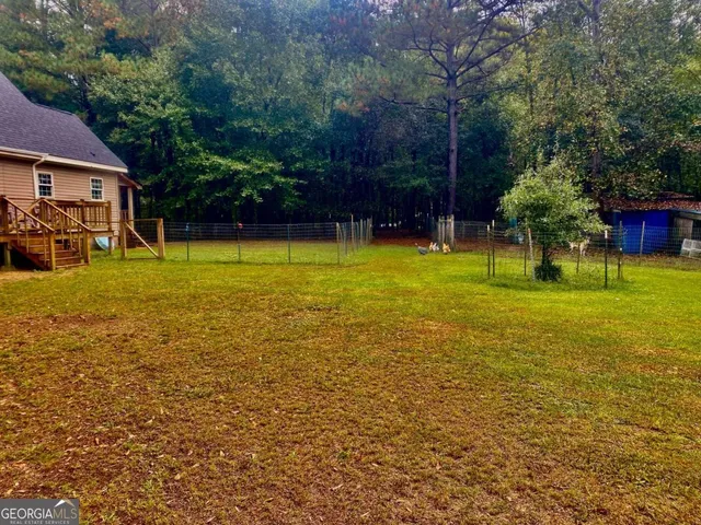 a view of a house with garden and sitting area