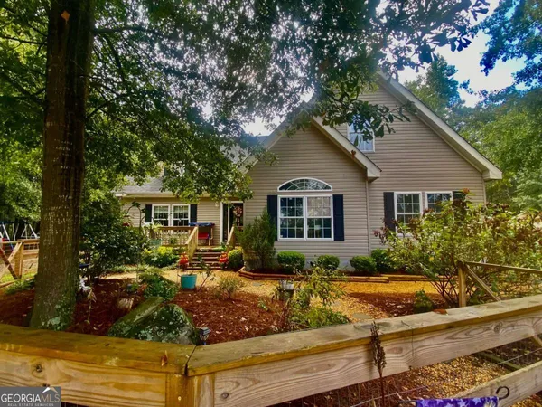 a view of a yard with large trees