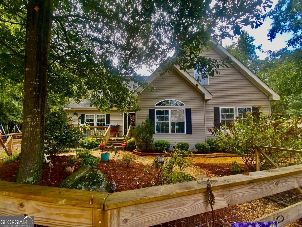 290 Poplar Creek Road Stephens, GA 30667 - Photo 2 of 68 a front view of a house with garden