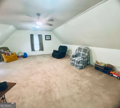 a spacious bedroom with a bed and a window