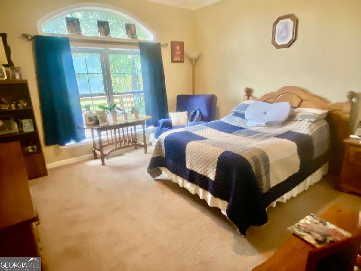 290 Poplar Creek Road Stephens, GA 30667 - Photo 44 of 68 a spacious bedroom with a bed and a window