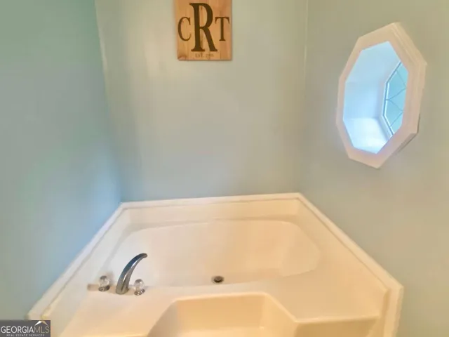 a kitchen with stainless steel appliances granite countertop a stove a refrigerator a sink a oven with wooden cabinets and floor