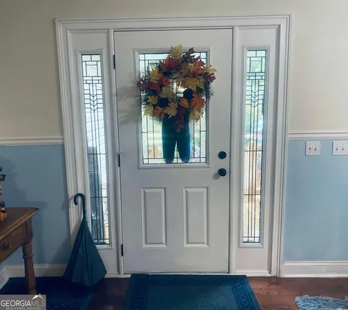 a view of swimming pool with a backyard and trees