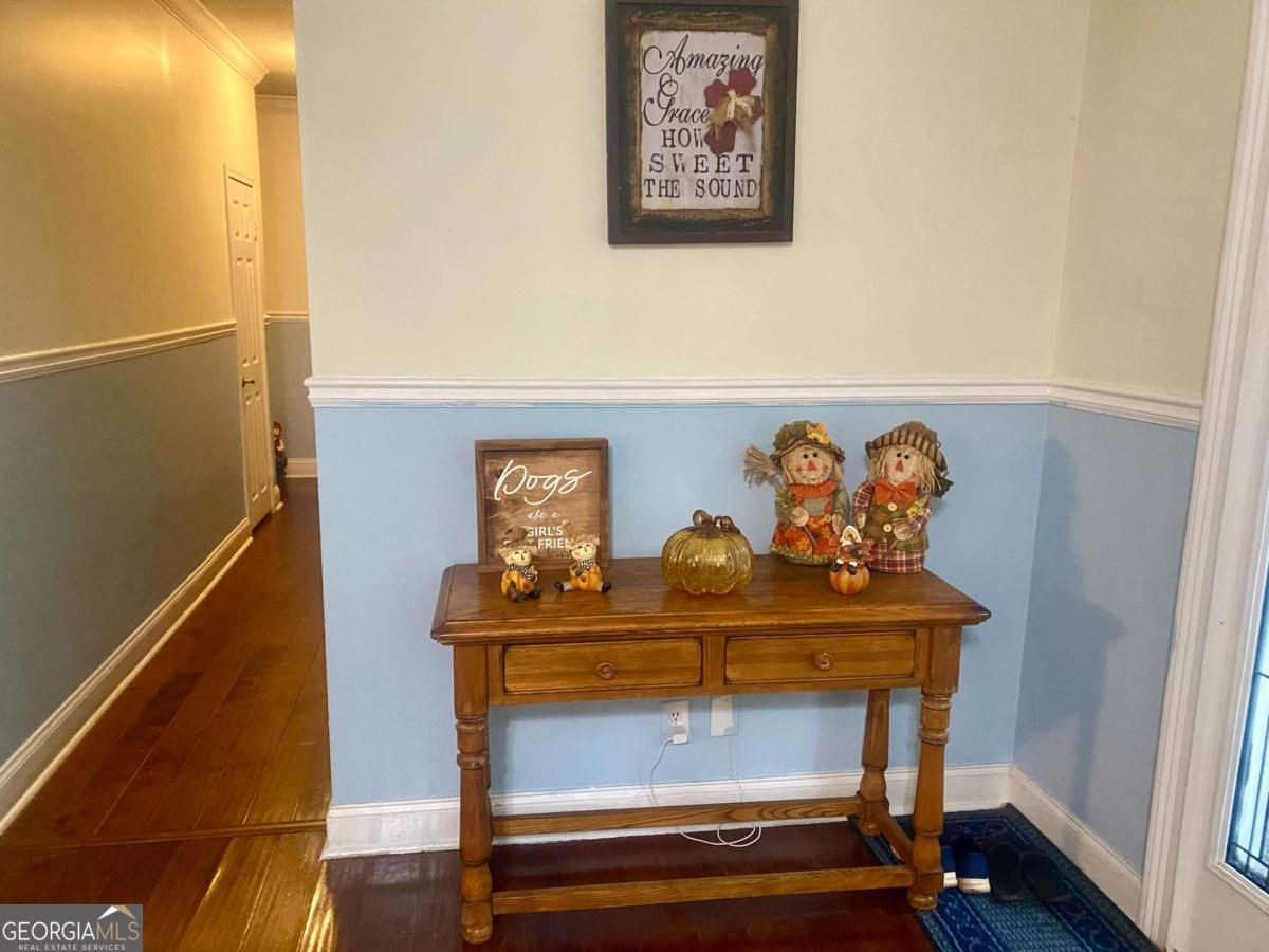 290 Poplar Creek Road Stephens, GA 30667 - Photo 50 of 68 a view of hallway with paintings on the wall and a window