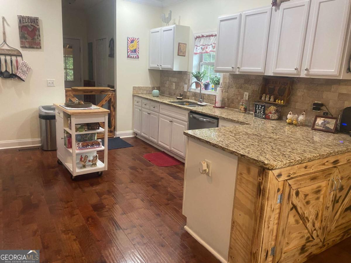 290 Poplar Creek Road Stephens, GA 30667 - Photo 63 of 68 a kitchen with a sink a stove and cabinets