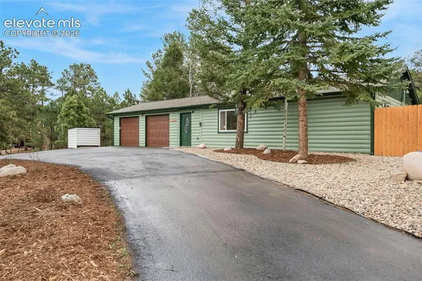a view of a house with a yard and garage
