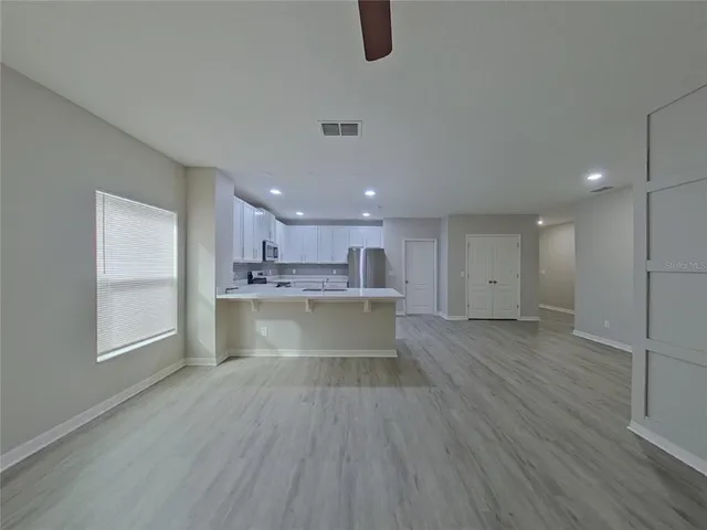 a view of kitchen with cabinets and wooden floor