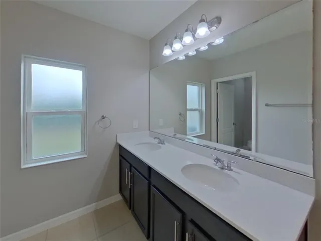 a bathroom with a sink double vanity and a mirror