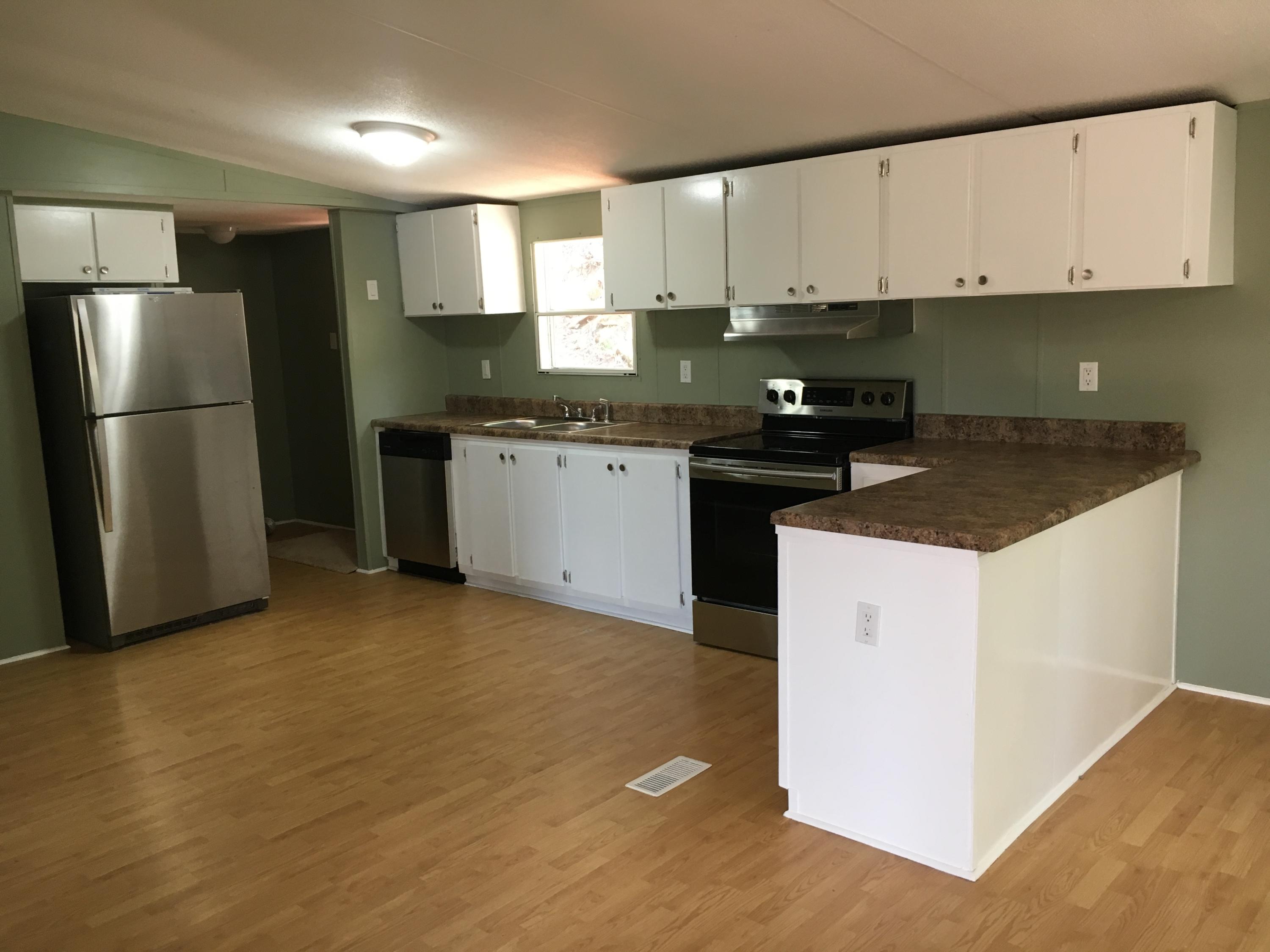 2205 Conner Grove Road Southwest Willis, VA 24380 - Photo 2 of 18 a kitchen with stainless steel appliances granite countertop a stove a sink and a refrigerator