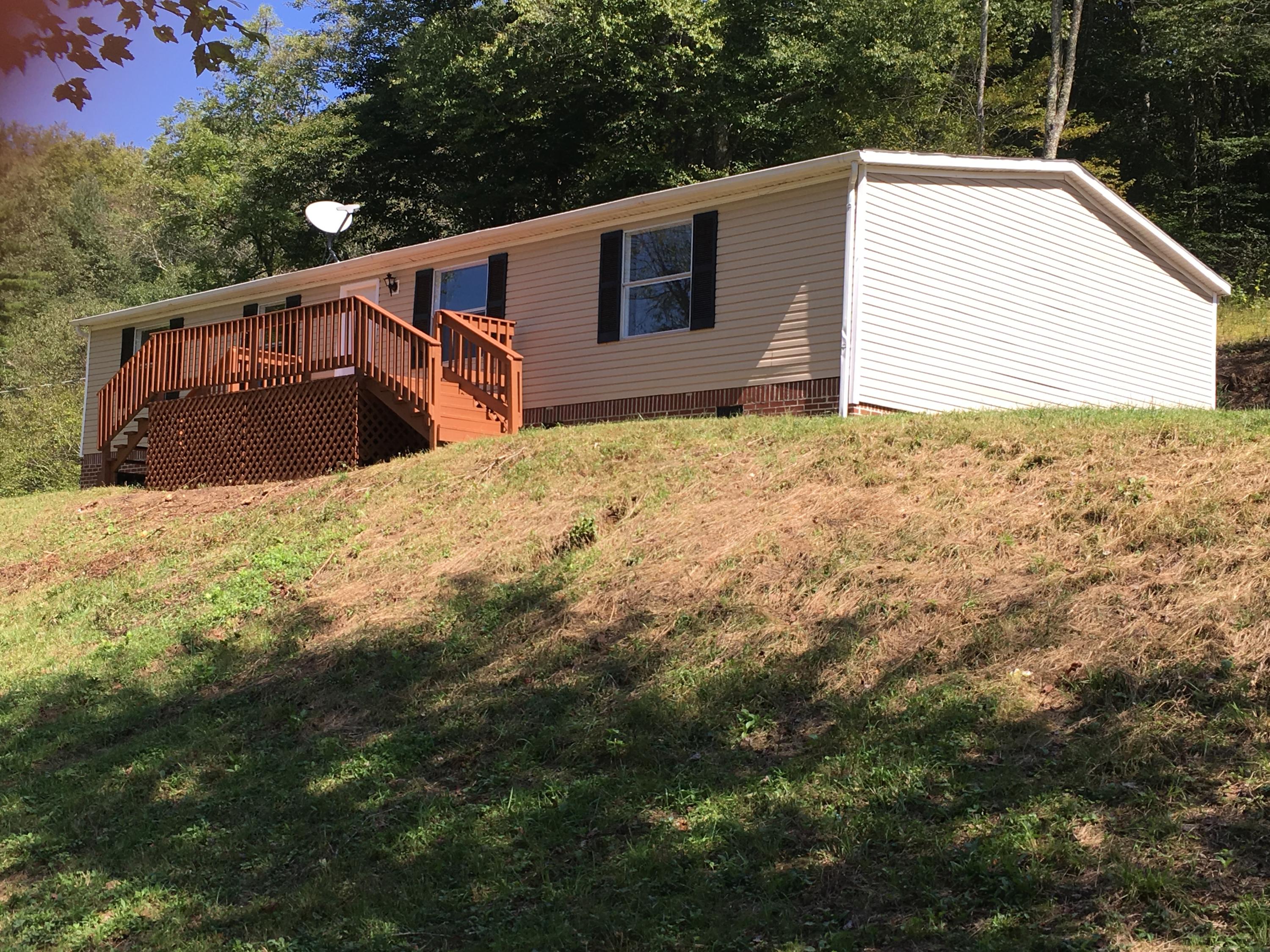 2205 Conner Grove Road Southwest Willis, VA 24380 - Photo 15 of 18 a house with trees in the background