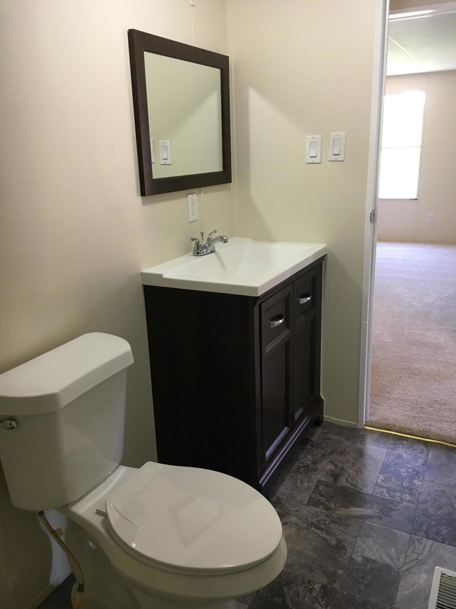2205 Conner Grove Road Southwest Willis, VA 24380 - Photo 5 of 18 a bathroom with a toilet sink and mirror