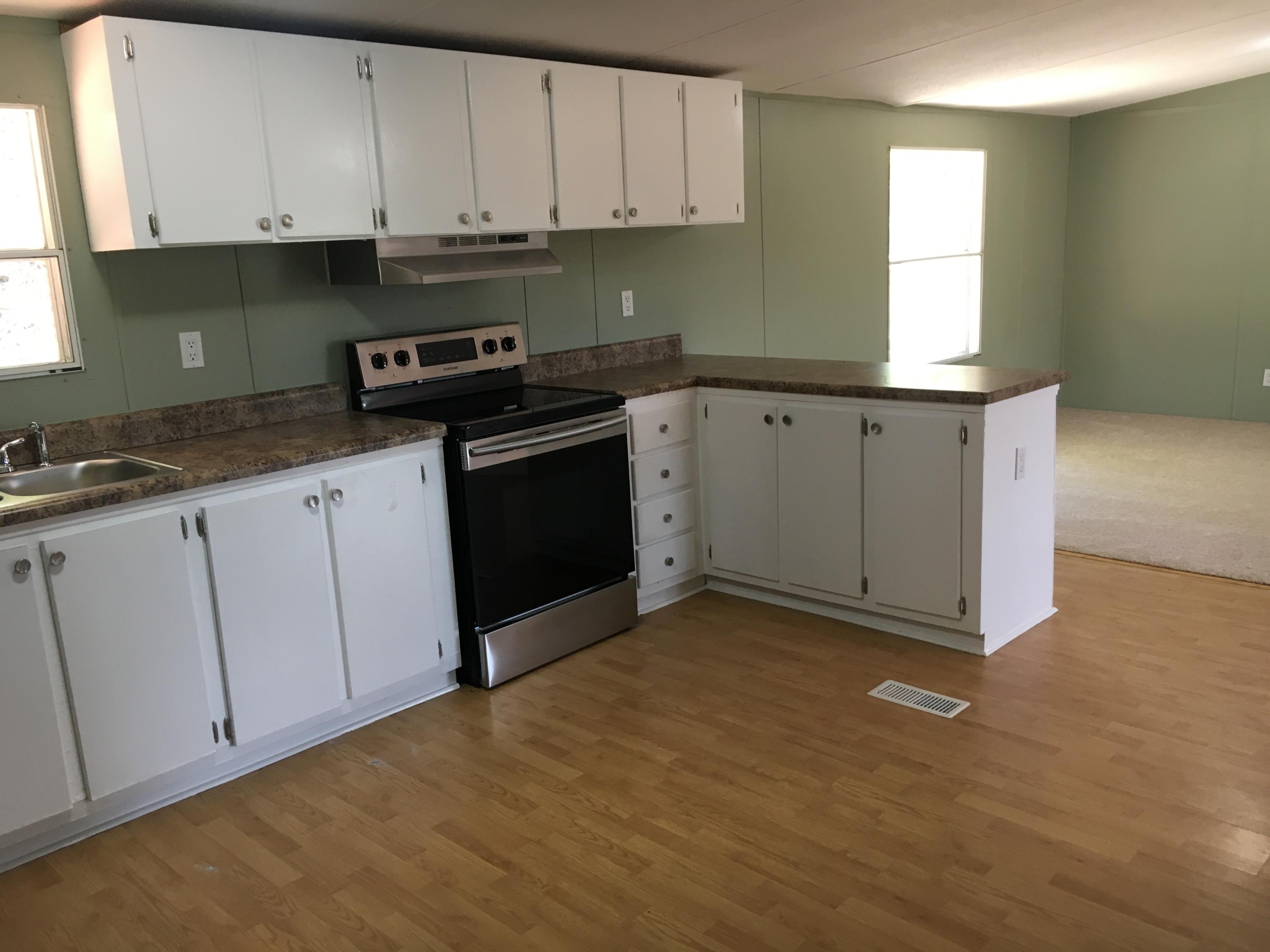 2205 Conner Grove Road Southwest Willis, VA 24380 - Photo 8 of 18 a kitchen with granite countertop white cabinets and white appliances