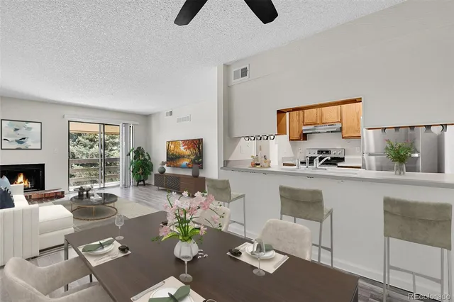 a living room with furniture kitchen view and a window