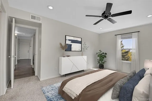 a bedroom with a bed and a painting on the wall