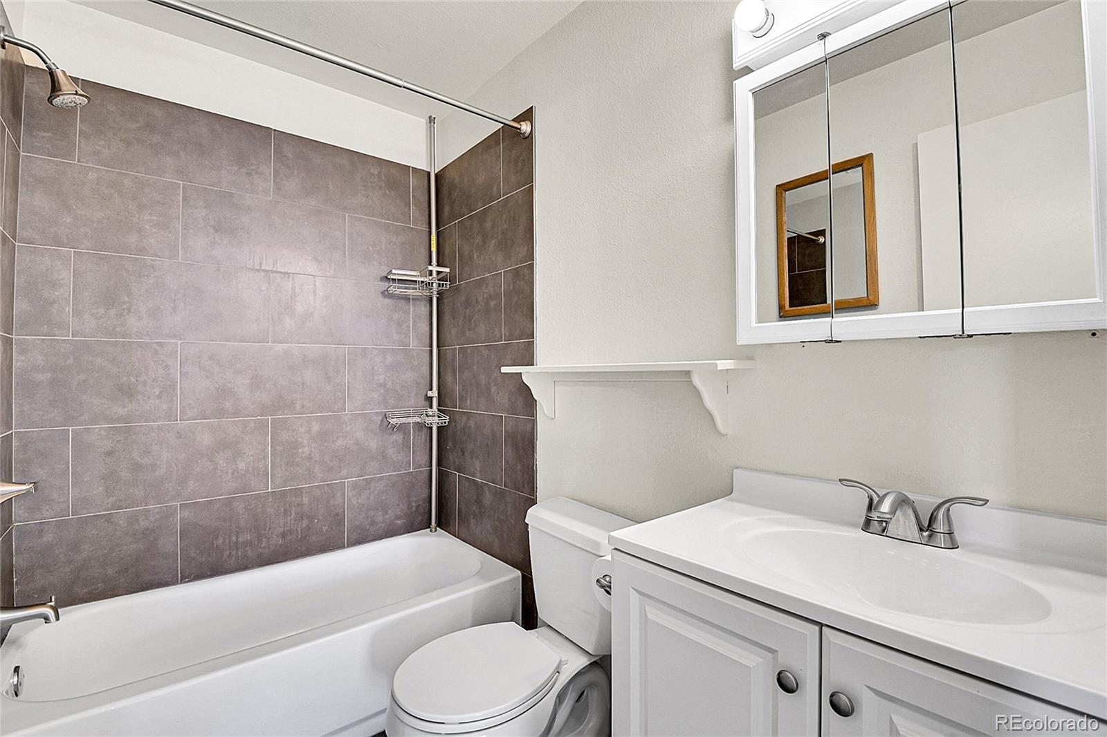 539 Wright Street, Unit 301 Lakewood, CO 80228 - Photo 14 of 32 a bathroom with a sink a toilet and bathtub