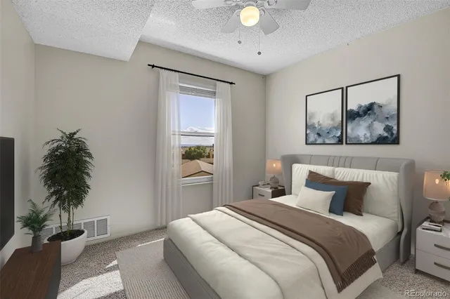 a bedroom with a bed and a potted plant