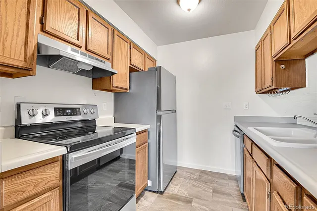 a kitchen with stainless steel appliances granite countertop a stove and a sink