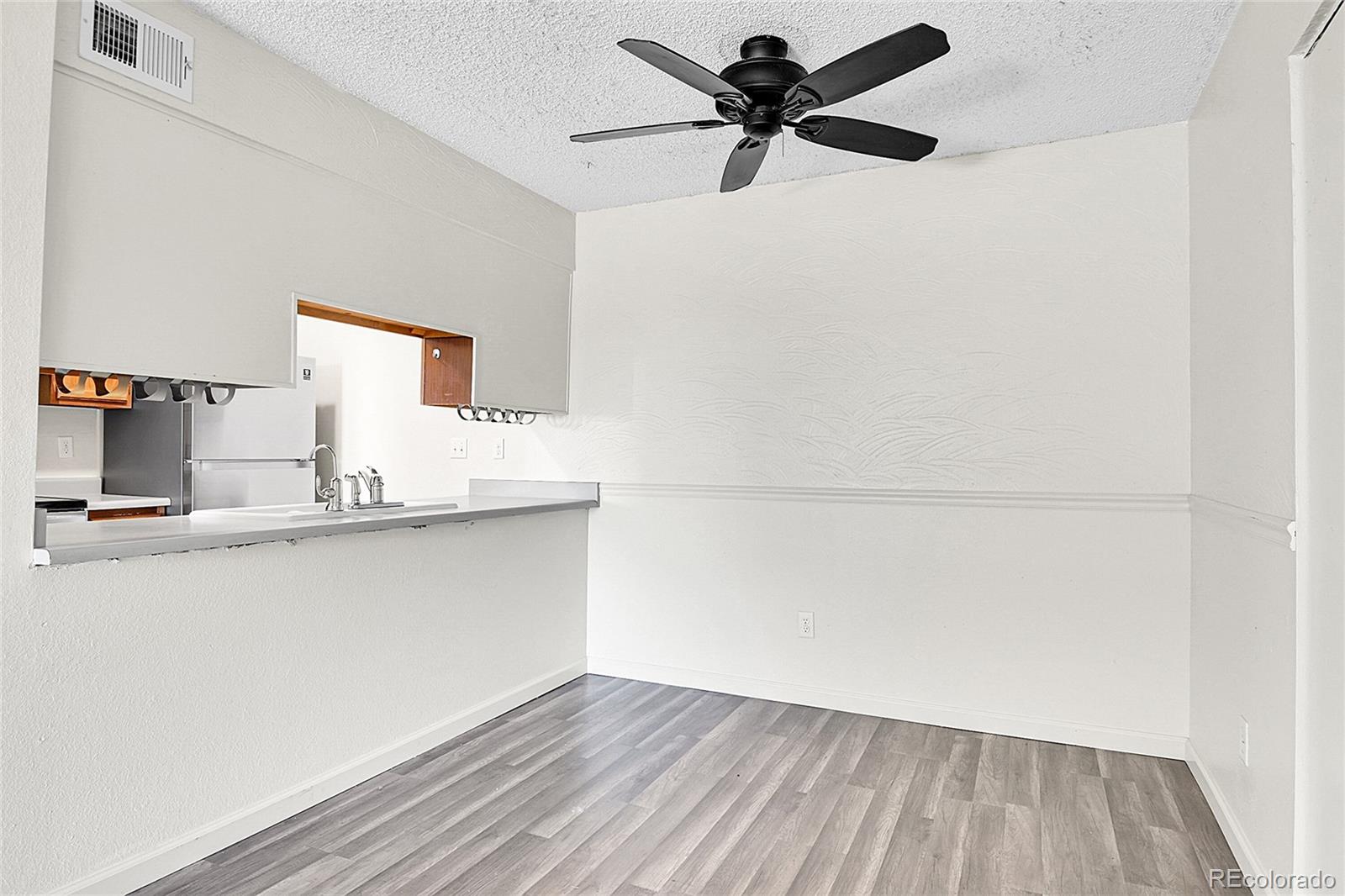 539 Wright Street, Unit 301 Lakewood, CO 80228 - Photo 19 of 32 a view of a kitchen with wooden floor and a sink