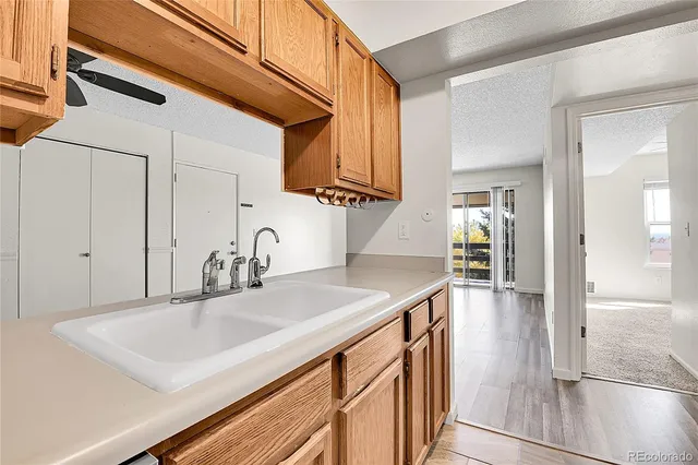 a kitchen with stainless steel appliances granite countertop a sink and a refrigerator
